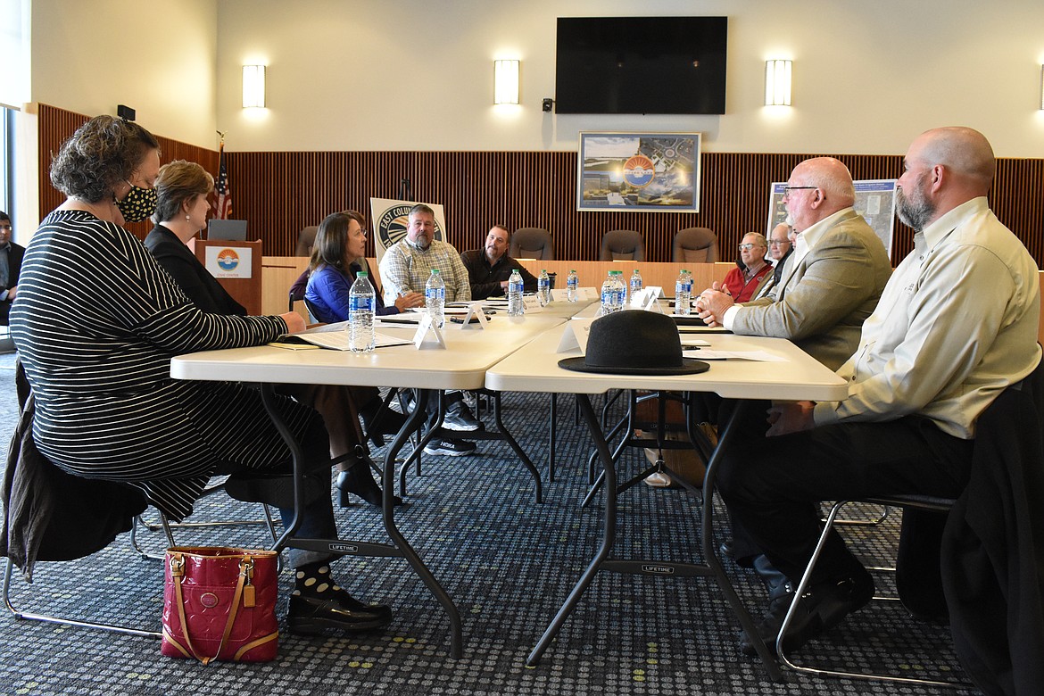 Leaders of the East Columbia Irrigation District speaking with one another at a Board Meeting